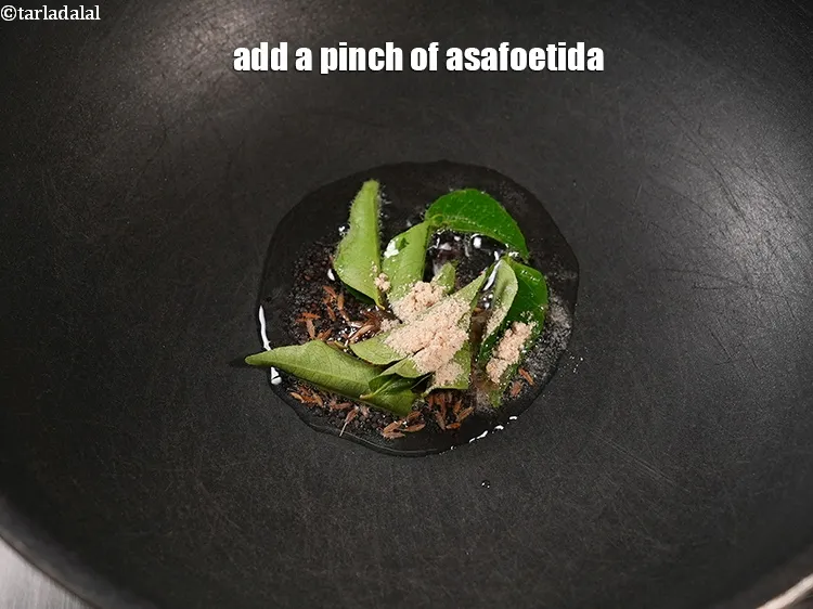 Step 18 – Add a pinch of <a href="https://www.tarladalal.com/glossary-asafoetida-hing-113i">asafoetida (hing)</a>.