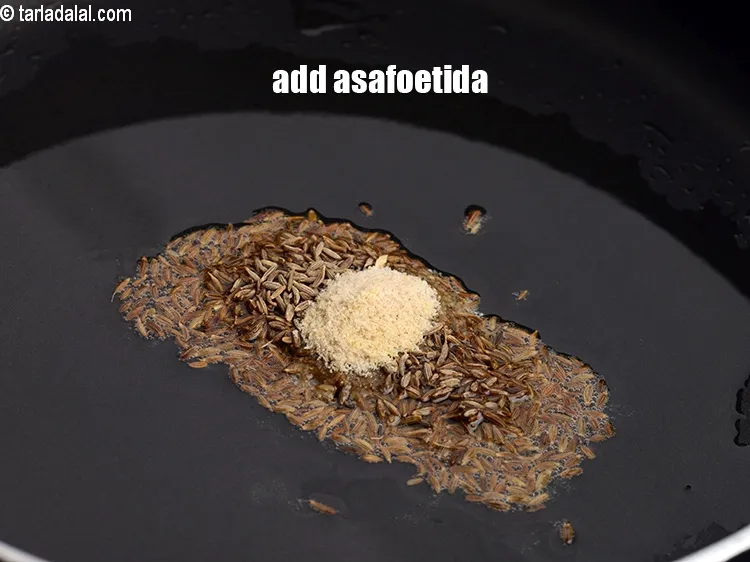 Step 19 – Add &frac14; tsp <a href="https://www.tarladalal.com/glossary-asafoetida-hing-113i">asafoetida (hing)</a>.