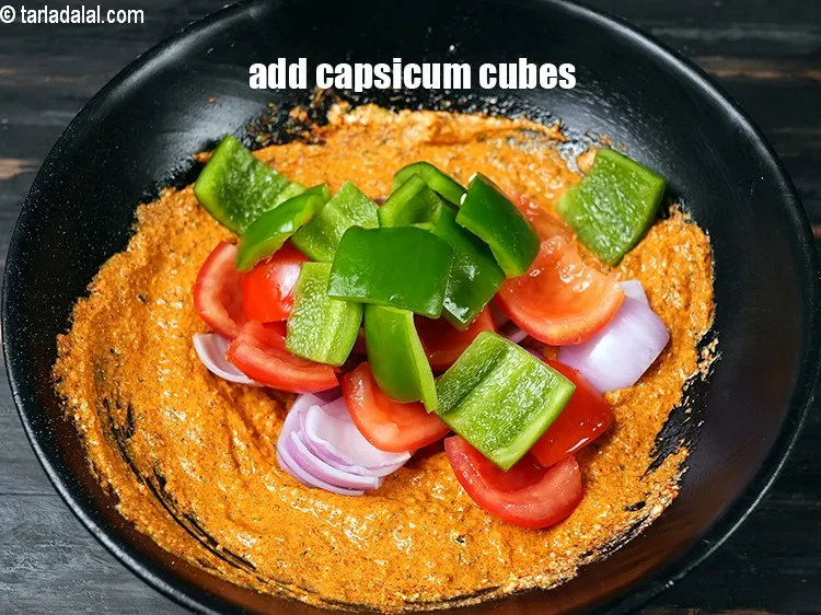 Step 19 – Add &frac12; cup <a href="https://www.tarladalal.com/glossary-capsicum-cubes-170i">capsicum cubes</a>.