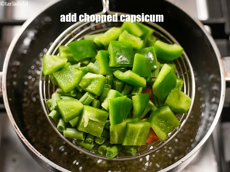 Step 19 – Add &frac12; cup <a href="https://www.tarladalal.com/glossary-chopped-capsicum-164i">chopped capsicum</a>.