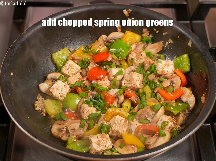 Step 18 – Add&nbsp;1/4 cup&nbsp;<a href="https://www.tarladalal.com/glossary-chopped-spring-onion-greens-1030i">chopped spring onion greens</a>.