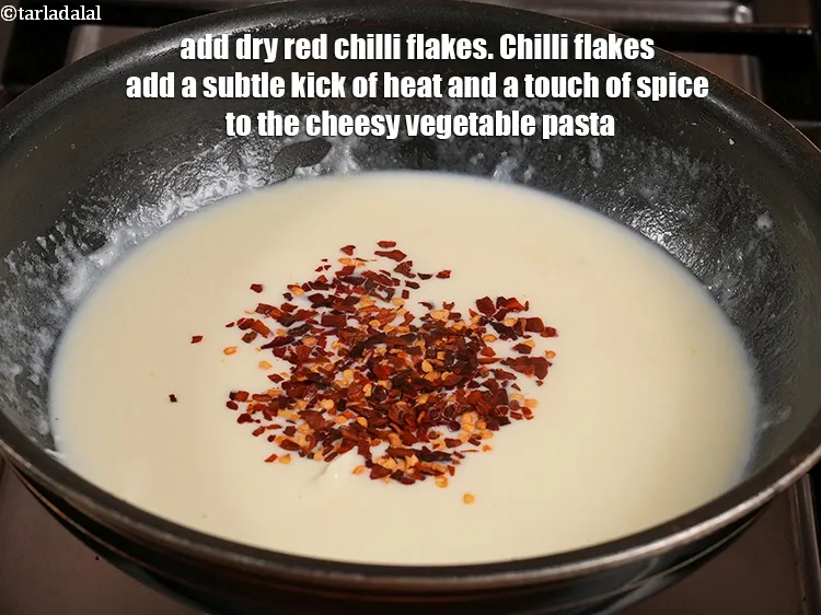 Step 18 – Add 1 tsp <a href="https://www.tarladalal.com/glossary-dry-red-chilli-flakes-paprika-338i">dry red chilli flakes (paprika)</a>. Chilli flakes add a subtle kick …