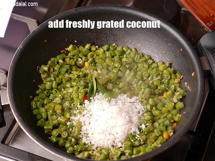 Step 18 – Add &frac14; cup freshly <a href="https://www.tarladalal.com/glossary-grated-coconut-852i">grated coconut</a>.