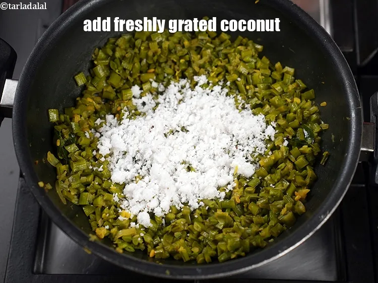 Step 18 – Add 3 tbsp freshly <a href="https://www.tarladalal.com/glossary-grated-coconut-852i">grated coconut</a>.