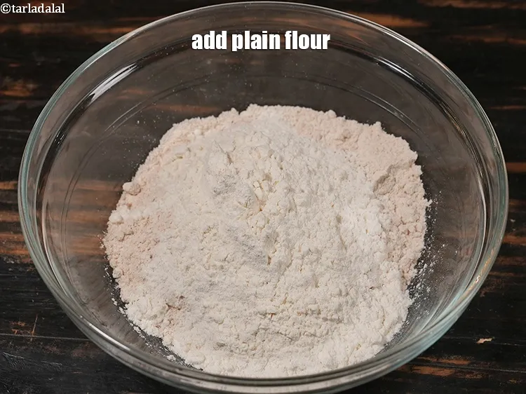 Step 18 – Add &frac14; cup <a href="https://www.tarladalal.com/glossary-plain-flour-maida-188i">plain flour (maida)</a>.