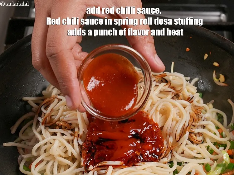 Step 18 – Add 1 tsp red <a href="https://www.tarladalal.com/glossary-red-chilli-sauce-lal-chilli-sauce-810i">chilli sauce</a>. &nbsp;Red chili sauce in spring roll dosa stuffing …
