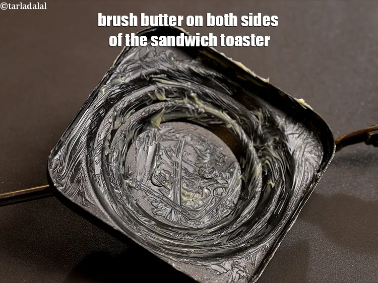 Step 18 – Brush 1 tsp <a href="https://www.tarladalal.com/glossary-butter-makhan-233i">butter</a>&nbsp;on both sides of the sandwich toaster.