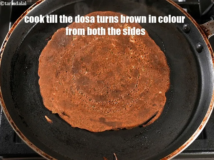 Step 18 – Cook on a high flame till the dosa turns brown in colour from both the …