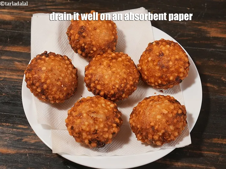 स्टेप 43 – वड़ों को तेल से निकाल लें और उन्हें कागज़ के …