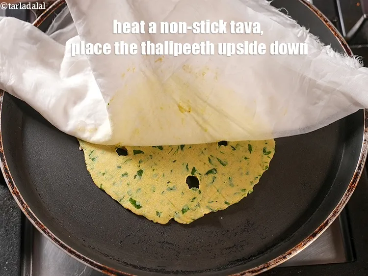 Step 20 – Heat a non-stick tava (griddle), place the thalipeeth upside down.