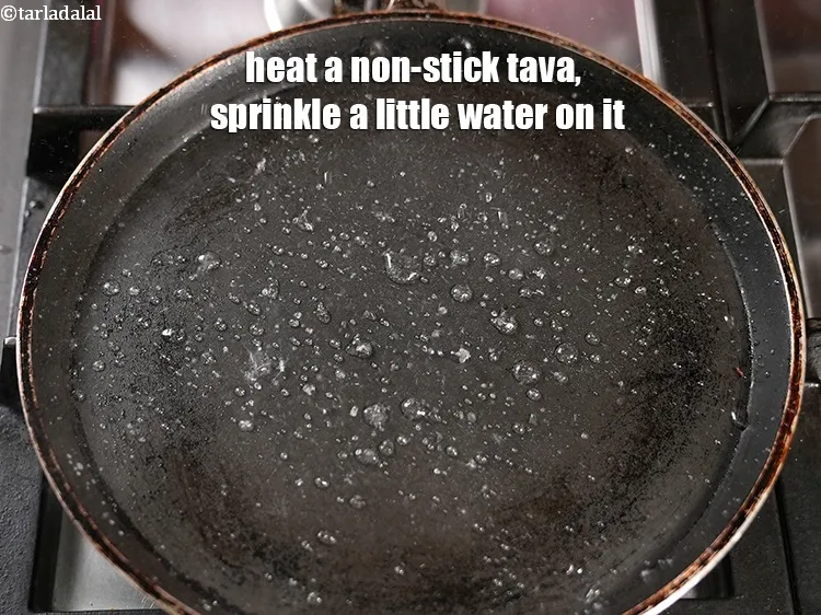 Step 18 – Heat a non-stick tava (griddle), sprinkle a little water on it.