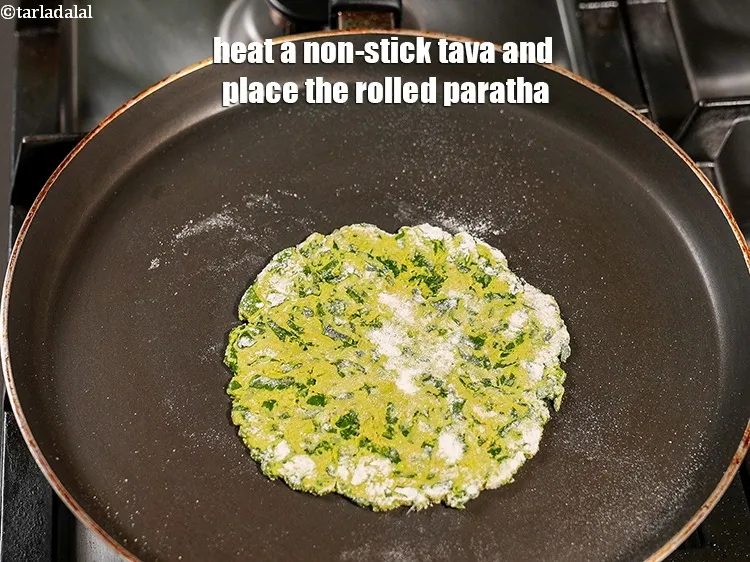 Step 18 – Heat a non-stick tava and place the rolled paratha.