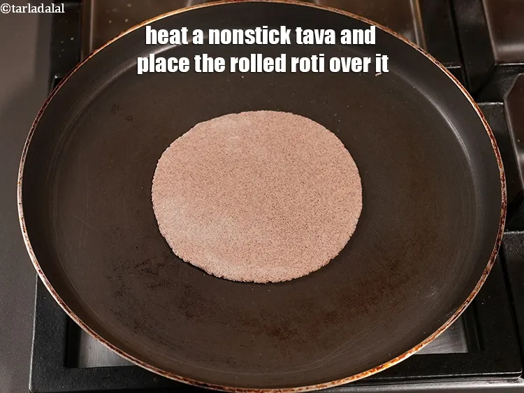 Step 18 – Heat a nonstick tava and place the rolled roti over it.