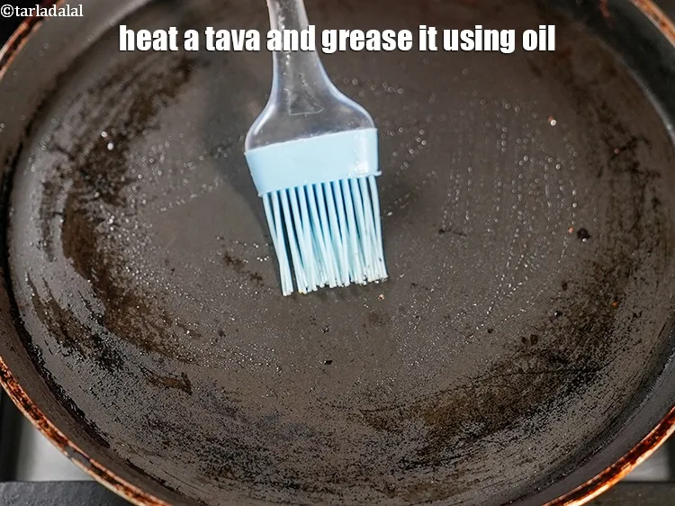 Step 18 – Heat a tava (griddle) and grease it using &frac12; tsp oil.