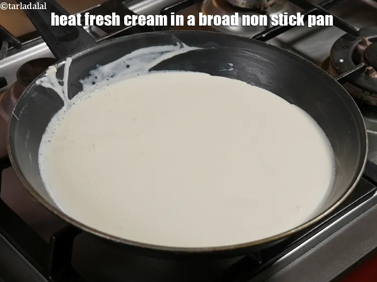 Step 18 – Heat 1&frac12; cups of <a href="https://www.tarladalal.com/glossary-fresh-cream-1877i">fresh cream</a> in a broad non stick pan.