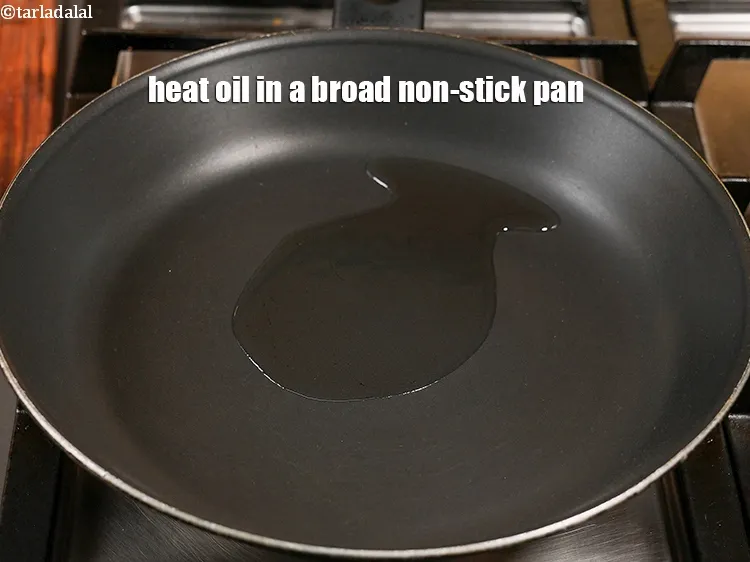 Step 18 – Heat 1&frac12; tbsp <a href="https://www.tarladalal.com/glossary-oil-671i">oil</a> in a broad non-stick pan.