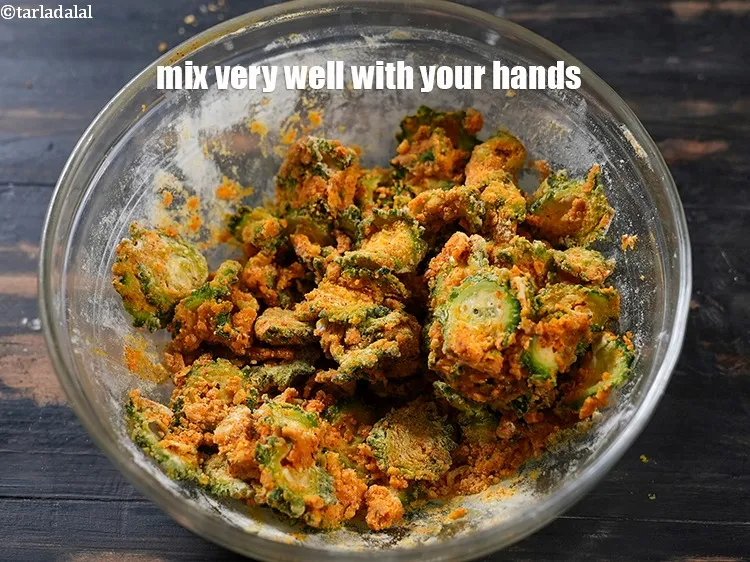Step 18 – Mix very well with your hands. The masala should coat the karela well.