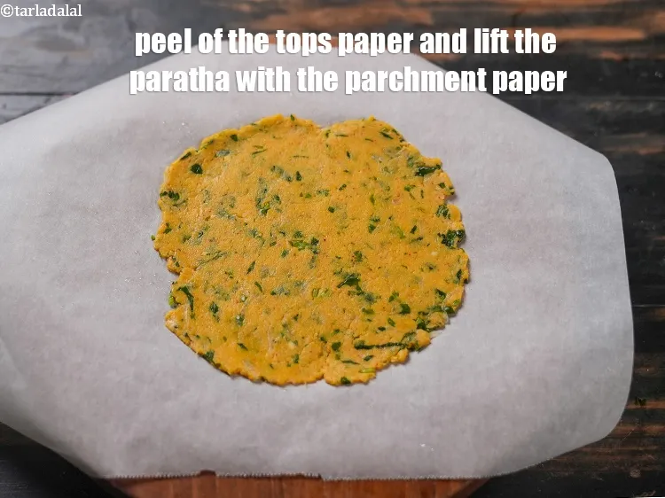 Step 18 – Peel of the tops paper and lift the paratha with the parchment paper.