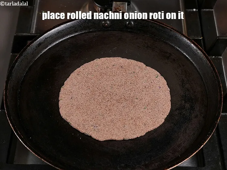 Step 20 – Place rolled nachni onion roti on it.