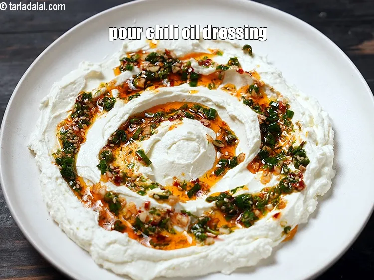 Step 18 – Pour the chili oil dressing over the hung curd.