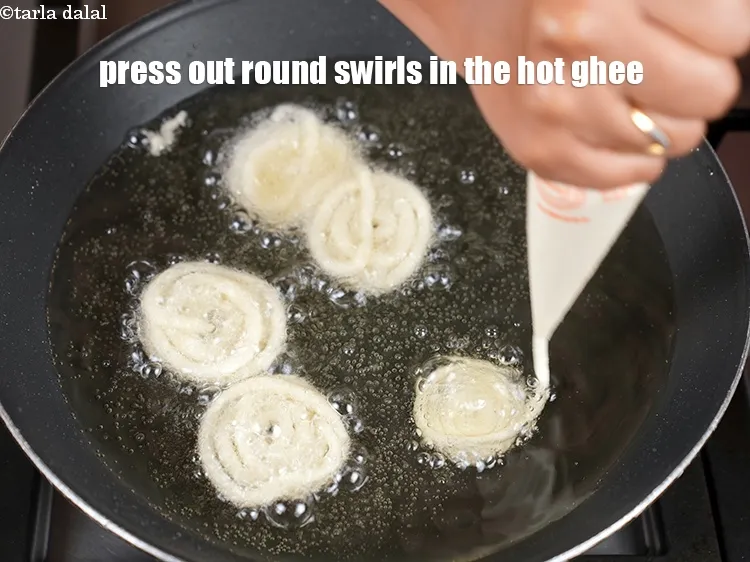 Step 20 – Press out round swirls of the batter in the hot ghee working closely from center …