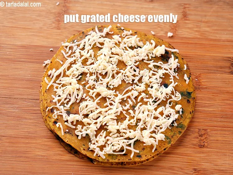 Step 18 – Put little grated cheese evenly over it.&nbsp;