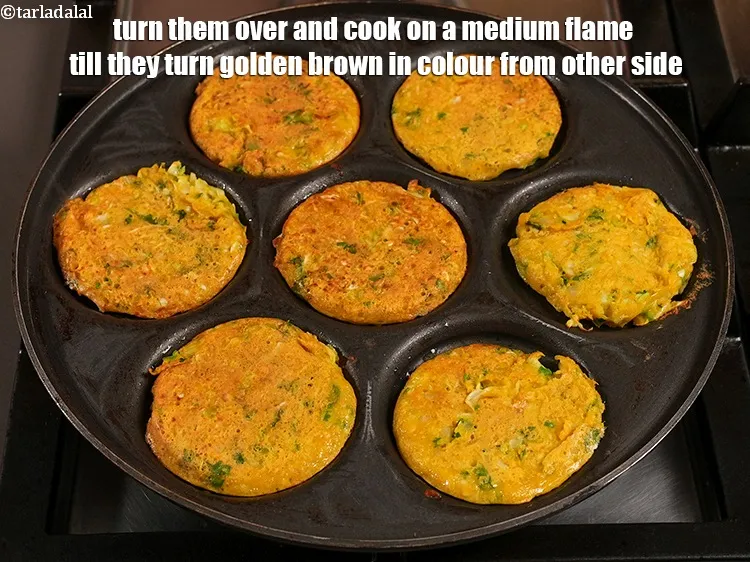 Step 32 – Turn them over and cook on a medium flame till they turn golden brown in …