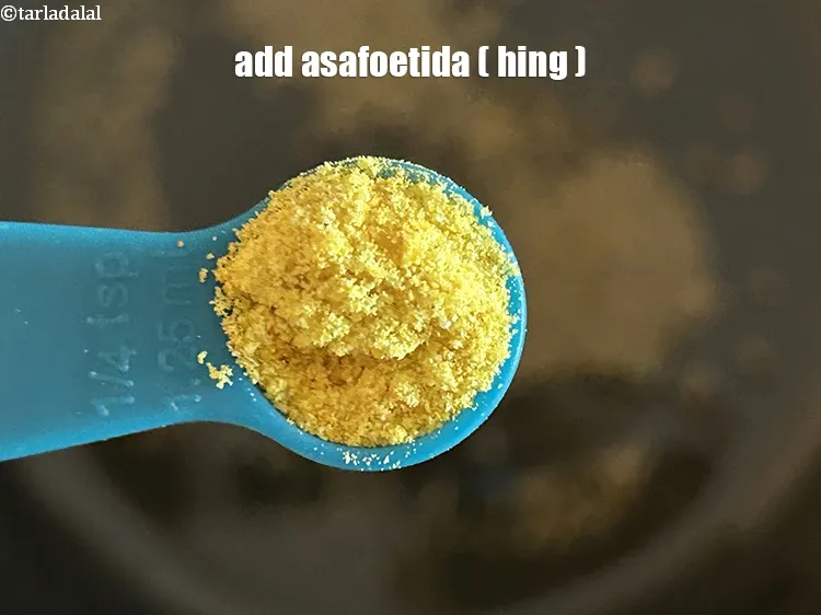 Step 18 – <html><head></head><body><p>Add&nbsp;1/4 tsp&nbsp;<a href="glossary-asafoetida-hing-113i">asafoetida (hing)</a>.</p></body></html>