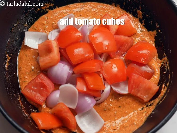 Step 18 – Add 3/4 cup <a href="https://www.tarladalal.com/glossary-tomato-cubes-728i">tomato cubes</a>.