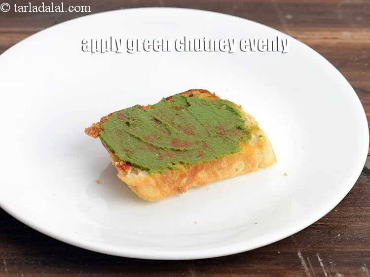 Step 17 – Apply &frac12; tsp&nbsp;<a href="https://www.tarladalal.com/green-chutney-22266r">green chutney</a> evenly over it.&nbsp;