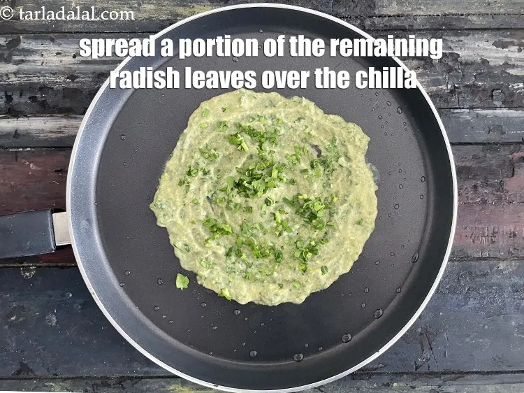 Step 29 – Spread a portion of radish leaves over the chilla. We have&nbsp;1/3 cup of radish leaves …