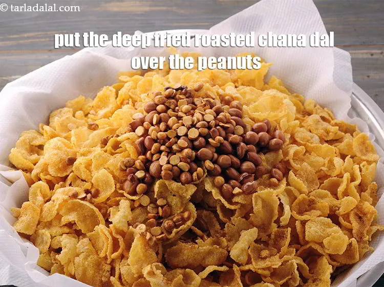 Step 20 – Drain well and place them over the deep-fried <a href="https://www.tarladalal.com/glossary-raw-peanuts-kachi-mungfali-kachi-moongfali-847i" target="_blank">peanuts</a>.