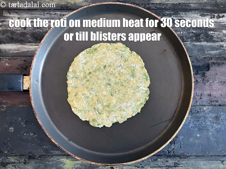 Step 19 – <meta charset="UTF-8" />Cook the bottom of the roti for 30 upto seconds on medium heat …