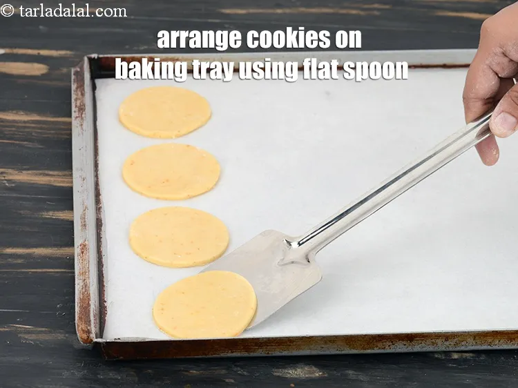 Step 18 – Arrange the cookies on a baking tray using a flat spoon.