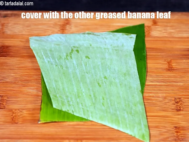 Step 33 – Place another banana leaf over it and press it lightly.