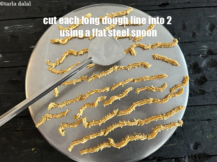 Step 19 – <meta charset="UTF-8" /> Cut each long dough line into 2 using a flat steel spoon.