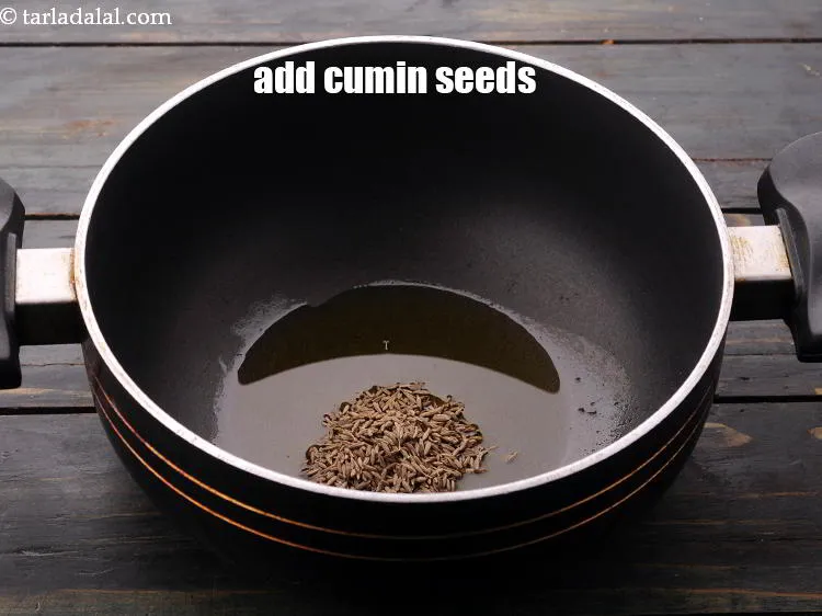 Step 32 – Add the <a href="https://www.tarladalal.com/glossary-cumin-seeds-jeera-zeera-381i" target="_blank">cumin seeds</a>.