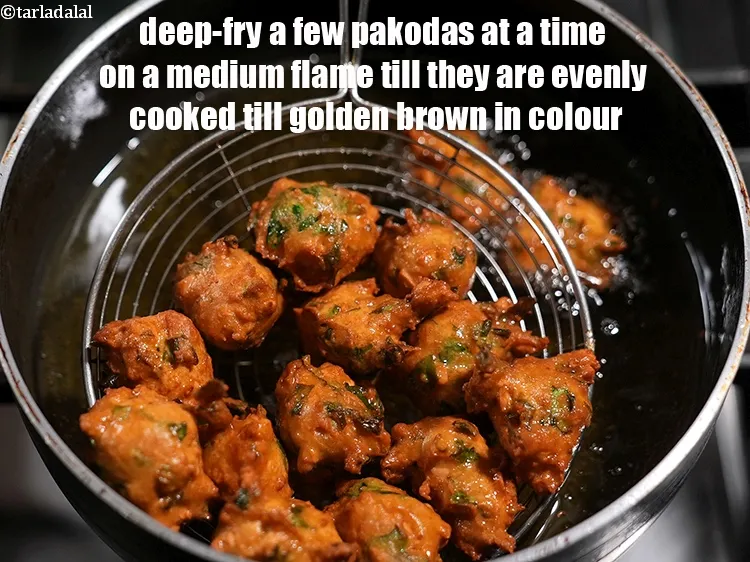 Step 24 – Deep-fry a few pakodas at a time on a medium flame till they are evenly …