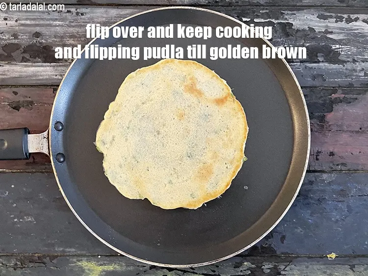 Step 24 – Flip over and keep cooking and flipping pudla till golden brown.