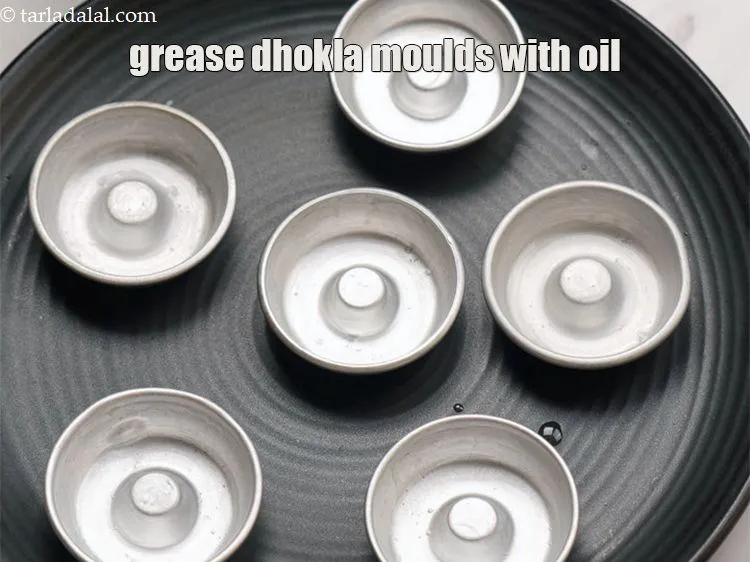 Step 18 – Grease the dhokla moulds with oil.