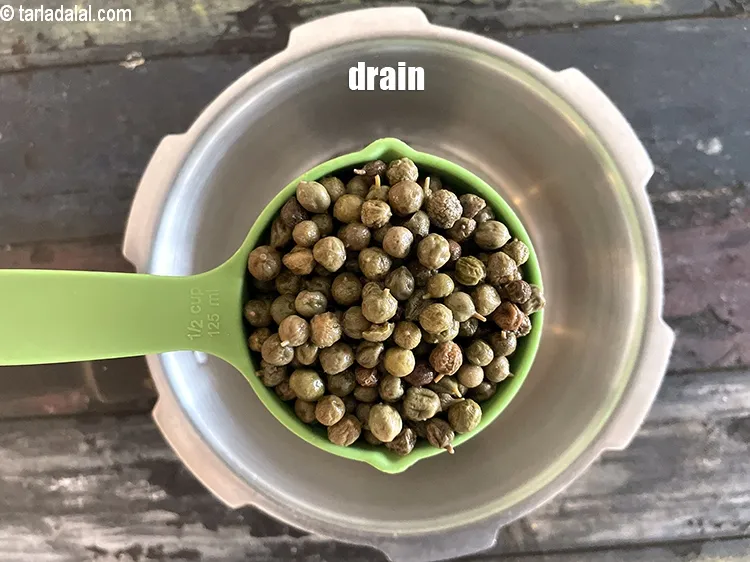 Step 21 – In a pressure cooker put 3/4th cup soaked, washed and drained&nbsp;<a href="glossary-ker-662i">ker</a>.