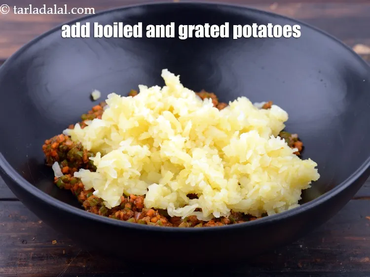 Step 18 – Add 1 cup&nbsp;boiled and&nbsp;<a href="https://www.tarladalal.com/glossary-grated-potatoes-867i">grated potatoes</a>.