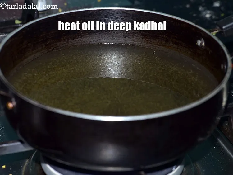 Step 18 – Heat the <a href="https://tarladalal.com/glossary-oil-671i">oil</a>&nbsp;in a deep non-stick kadhai.