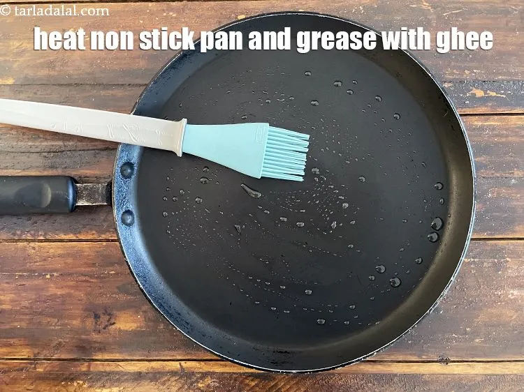 Step 24 – Heat a non-stick tava (griddle) and grease it with ghee.