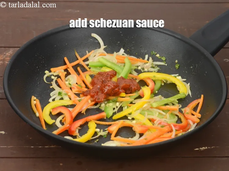 Step 18 – Add 2 tbsp&nbsp;<a href="https://www.tarladalal.com/glossary-schezwan-sauce-schezuan-sauce-1872i">schezwan sauce</a>.&nbsp;