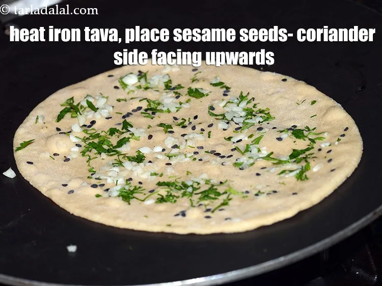 स्टेप 19 – एक लोहे का तवा गरम करें, उस पर तिल और …