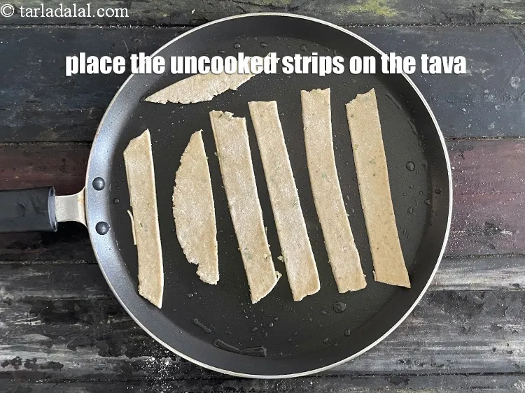 Step 19 – Place the 8 uncooked strips on the tava.