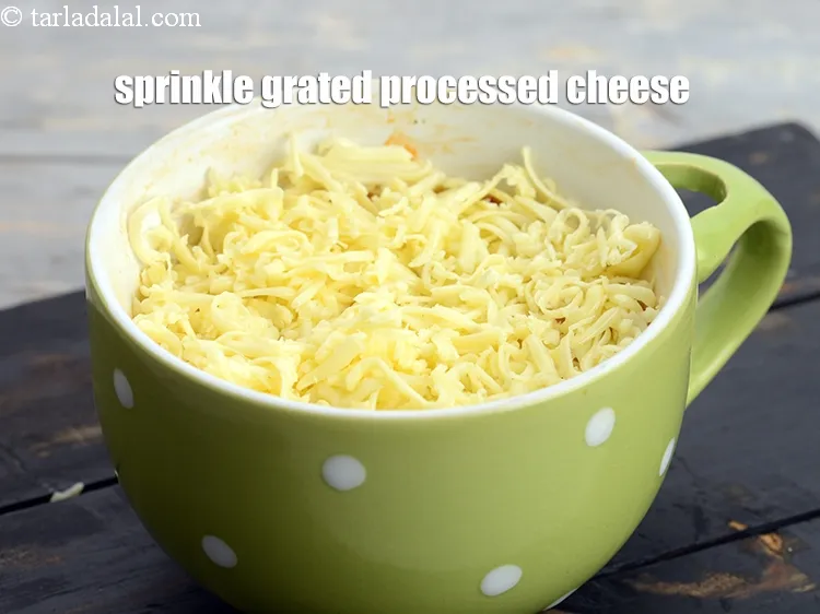 Step 18 – Sprinkle &frac14; cup <a href="https://www.tarladalal.com/glossary-grated-processed-cheese-868i">grated processed cheese</a> evenly over it.&nbsp;