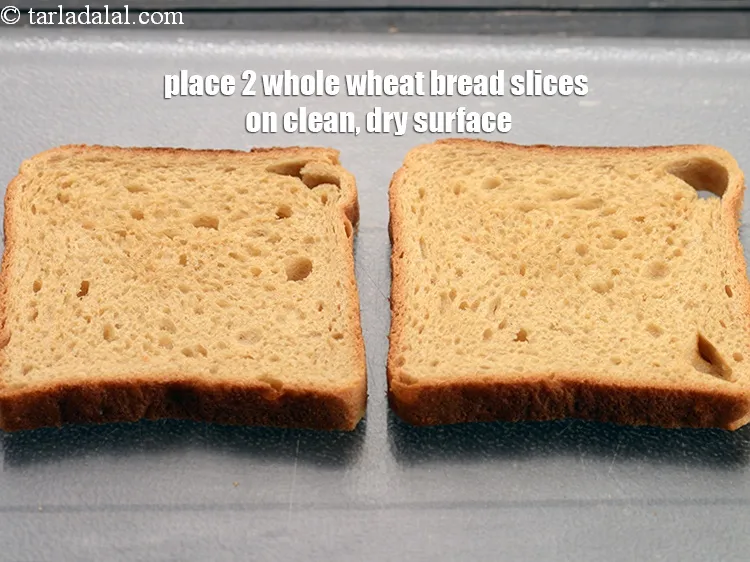 Step 18 – Place 2 <a href="https://www.tarladalal.com/glossary-whole-wheat-bread-gehun-ka-bread-855i">whole wheat bread slices</a> on a clean, dry surface.