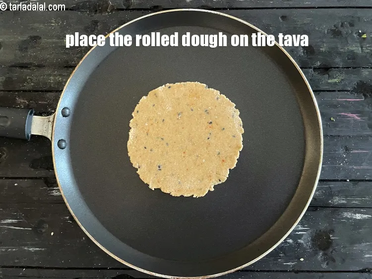 Step 18 – <meta charset="UTF-8" />Place the rolled out&nbsp;<strong>Khakhra</strong>&nbsp;dough on it.&nbsp;&nbsp;<br /> &nbsp;